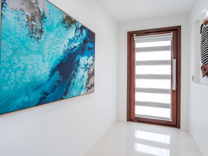 Artistic hallway showcasing coastal artwork.