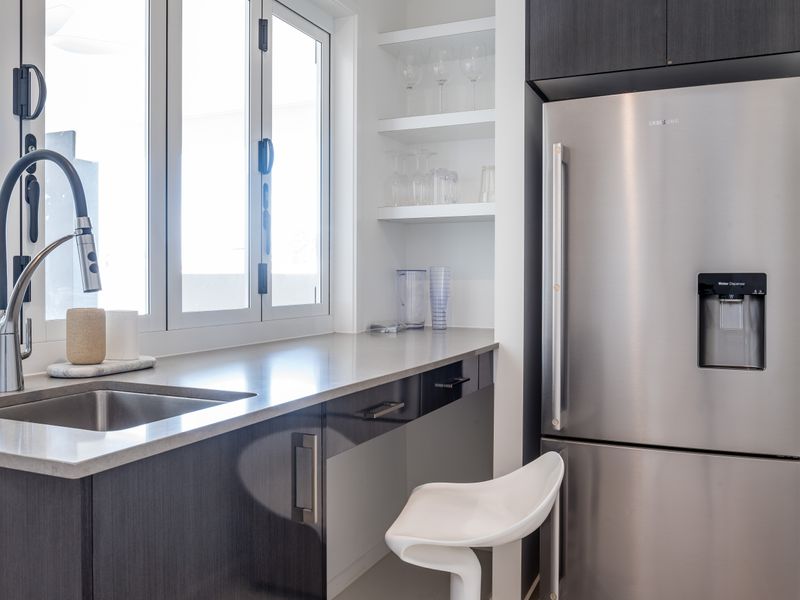Polished kitchen nook with stainless steel fridge.