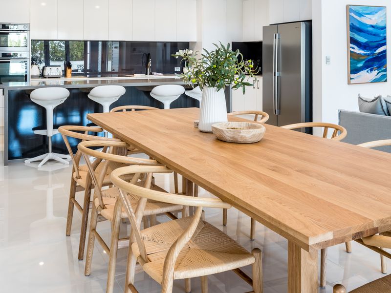 Family-sized dining table overlooking the kitchen area.
