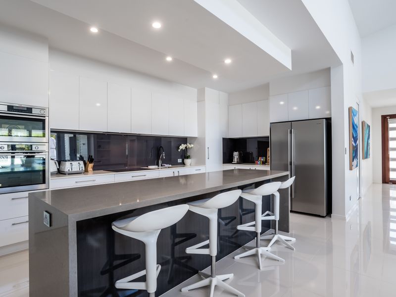 Sleek kitchen with breakfast bar and modern appliances.