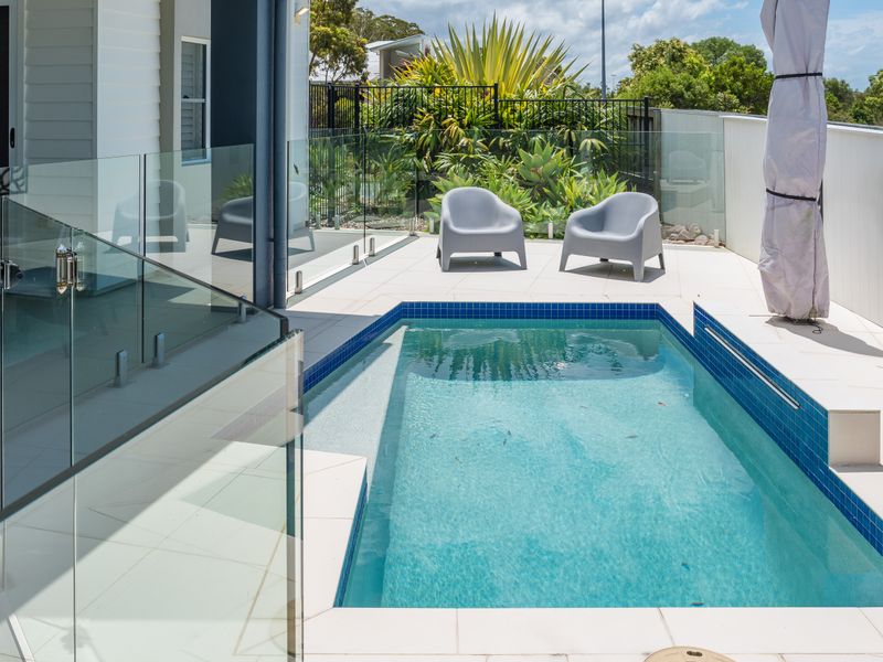 Crystal-clear pool with modern glass fencing.