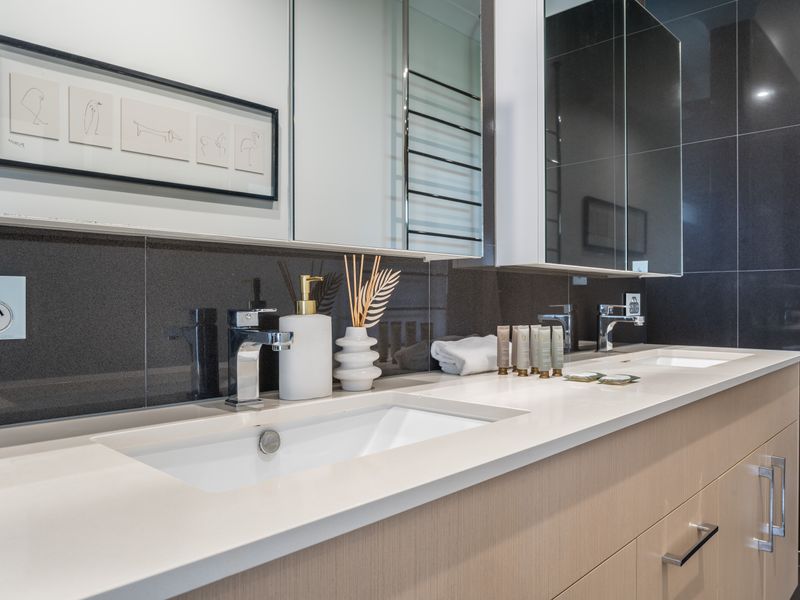 Ensuite with sleek fittings and large vanity mirror.