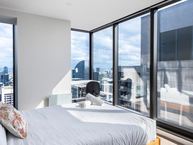 Inviting guest bedroom with soft bedding and city backdrop