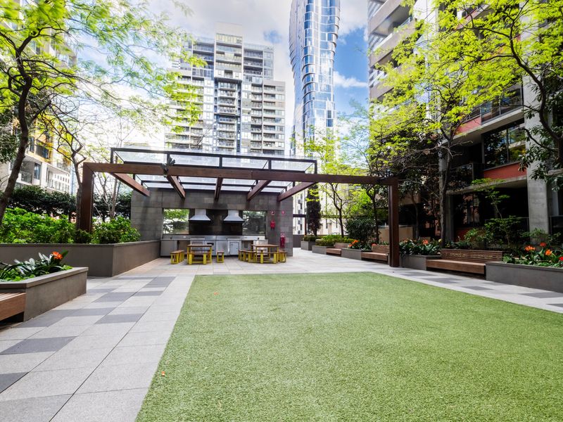 Landscaped courtyard with BBQ and dining area