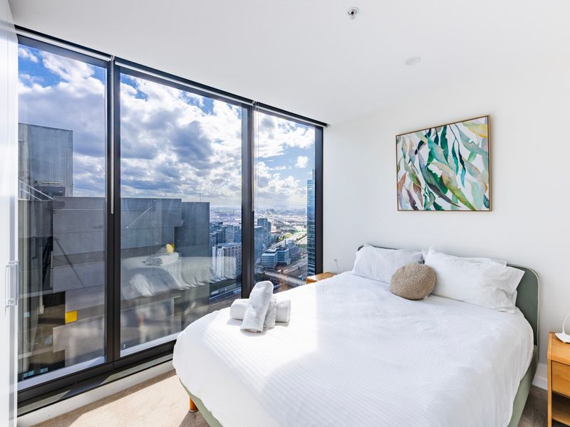 Master bedroom featuring a large window and city outlook