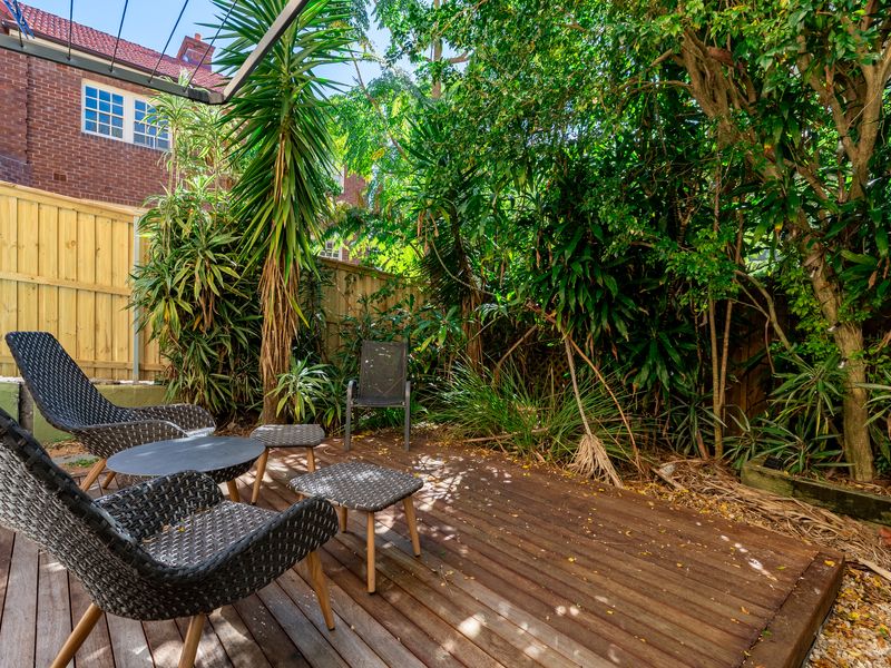 Relaxing outdoor deck surrounded by lush greenery