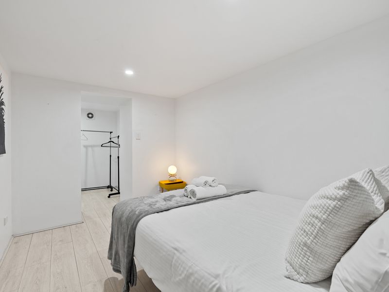 Spacious master bedroom with queen bed and crisp linens