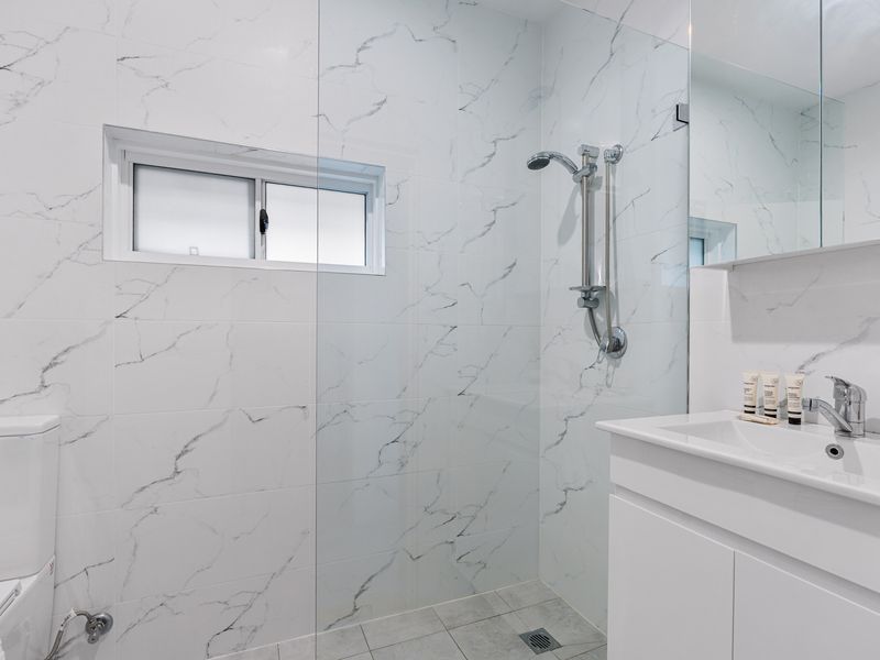 Bright and modern bathroom with walk-in shower and sleek finish