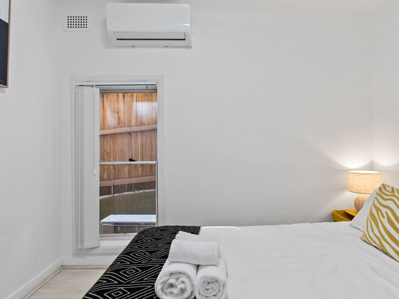 Peaceful guest bedroom with natural light and fresh design