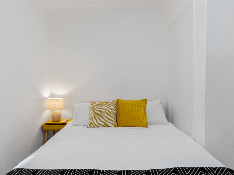 Cozy bedroom with double bed and soft lighting