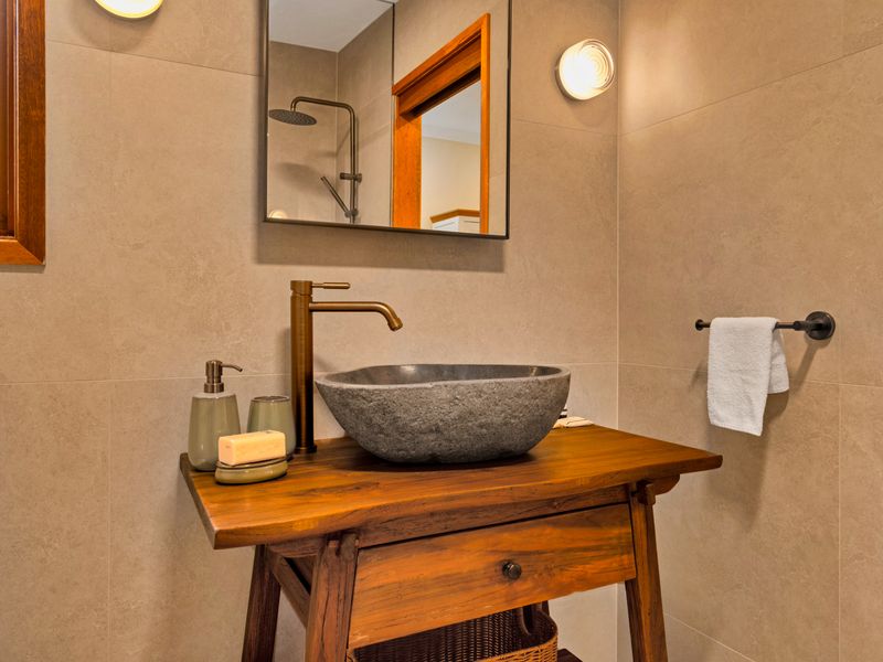 Enjoy modern amenities in a serene bathroom setting.