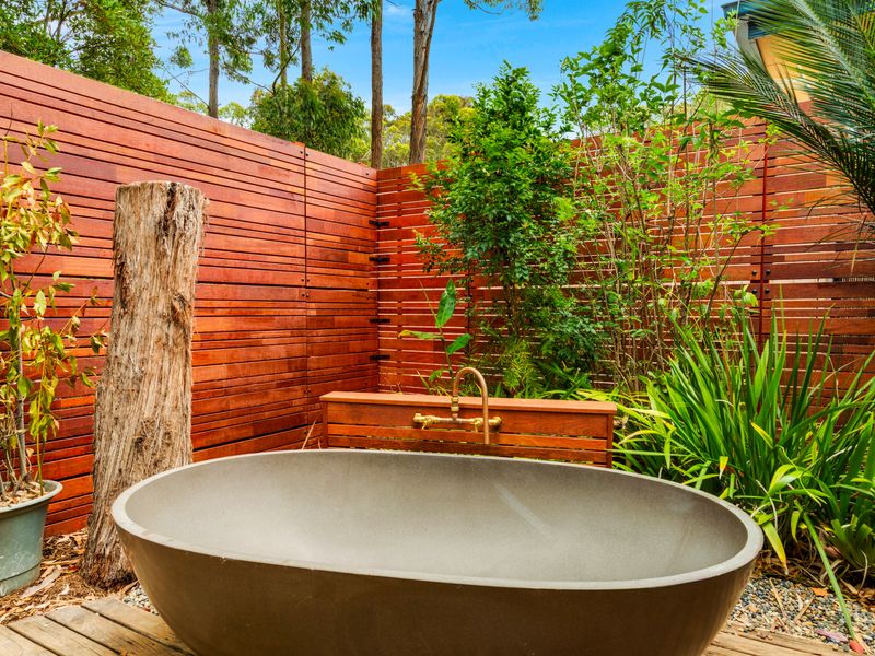 Enjoy a peaceful soak in this outdoor bath setting.