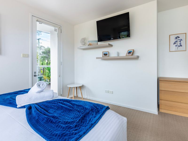Peaceful bedroom with private deck access.