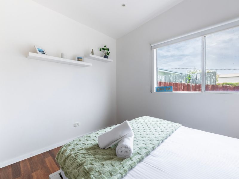 Simple, airy guest room perfect for a relaxing stay.