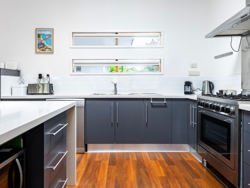 Modern kitchen with sleek finishes and appliances.
