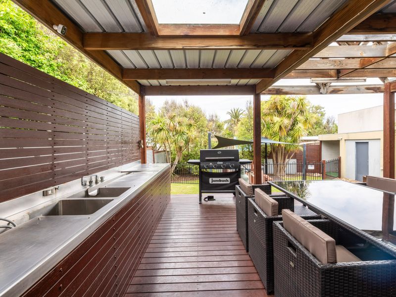 Alfresco lounge with BBQ and sink area.