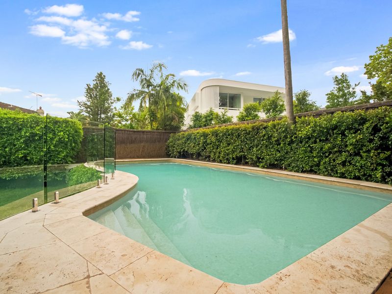 Inviting outdoor pool surrounded by lush greenery