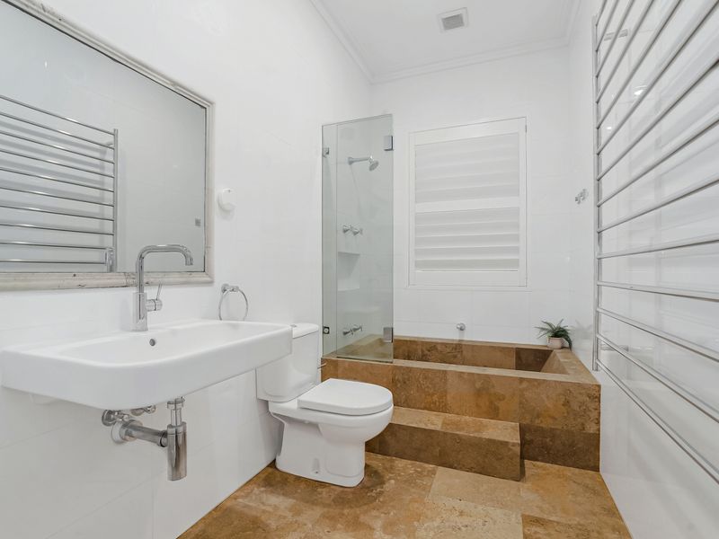 Bright bathroom with walk-in shower and sleek design