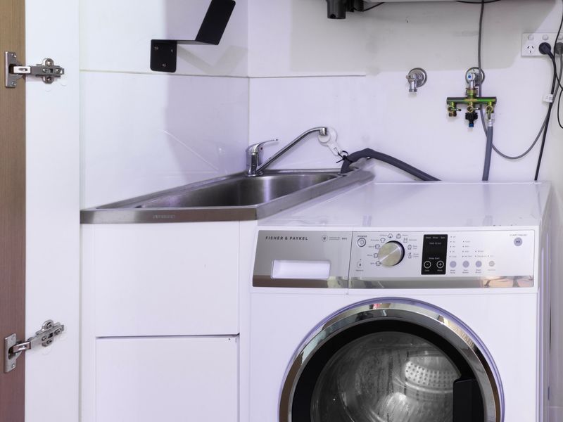 Convenient in-unit laundry with washer, dryer, and sink for extended stays.