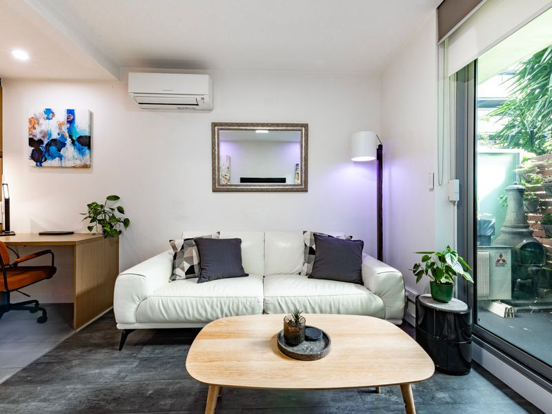 Bright and cozy lounge with comfy seating and natural light flowing through the glass doors.