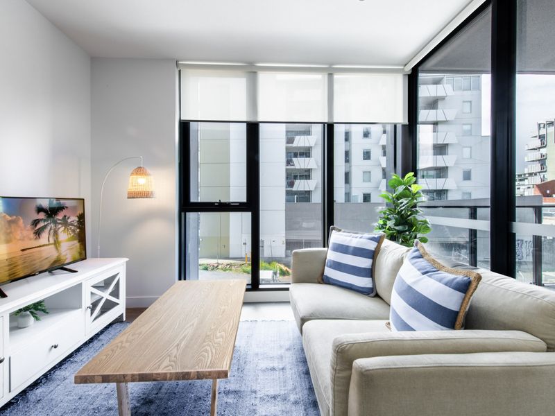 Comfortable living room with stylish décor and large windows.