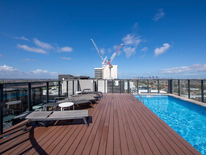 Rooftop pool with sun loungers and city views, perfect for relaxing under the sun.
