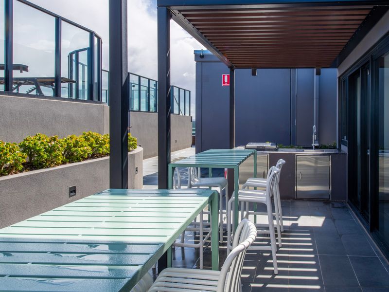 Al fresco dining with modern furnishings and partial shade.