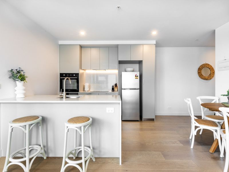 Sleek kitchen island with bar stools, perfect for casual dining.