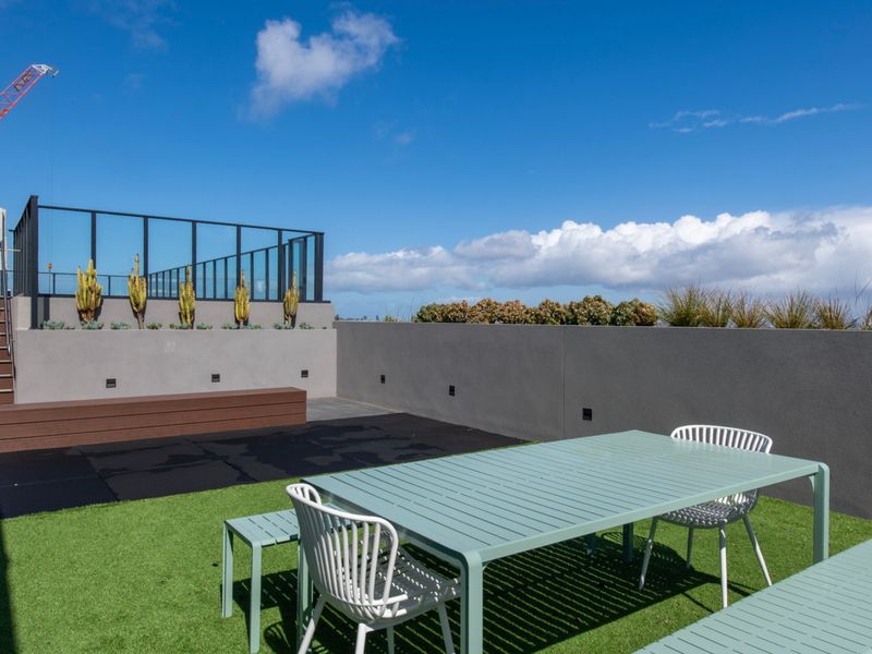 Open-air rooftop seating area with tables and chairs, ideal for casual gatherings or work.