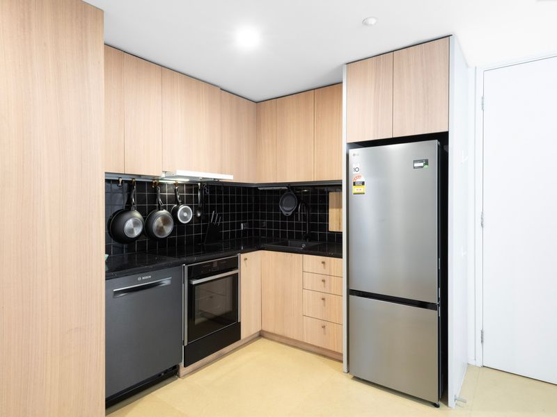 Modern kitchen with ample storage, stainless steel appliances, and essentials.