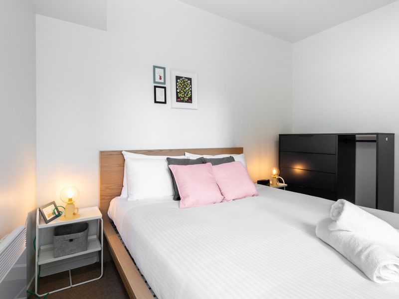 Comfortable and bright bedroom with soft lighting and plenty of space.