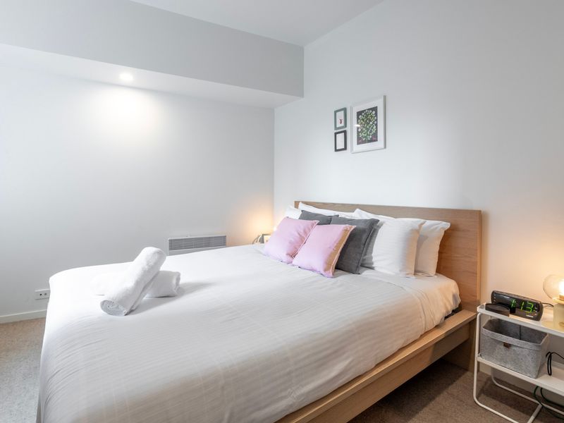 Peaceful bedroom with crisp linens and calming neutral tones.