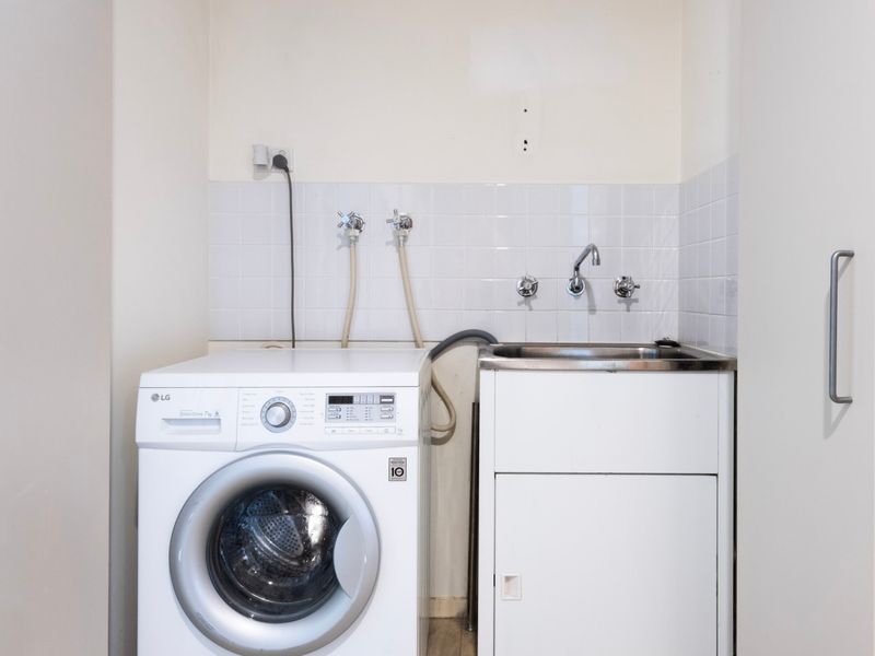 In-unit laundry with washer and sink for extended guest convenience.