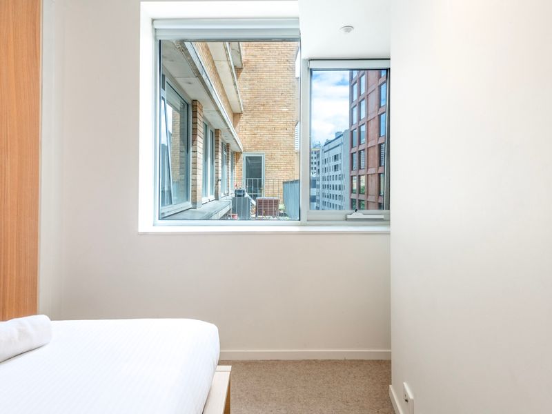 Large window brings in natural light and a glimpse of the city view.