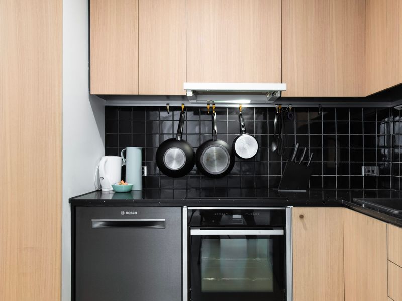 Fully equipped kitchen featuring stovetop, oven, and sleek finishes.