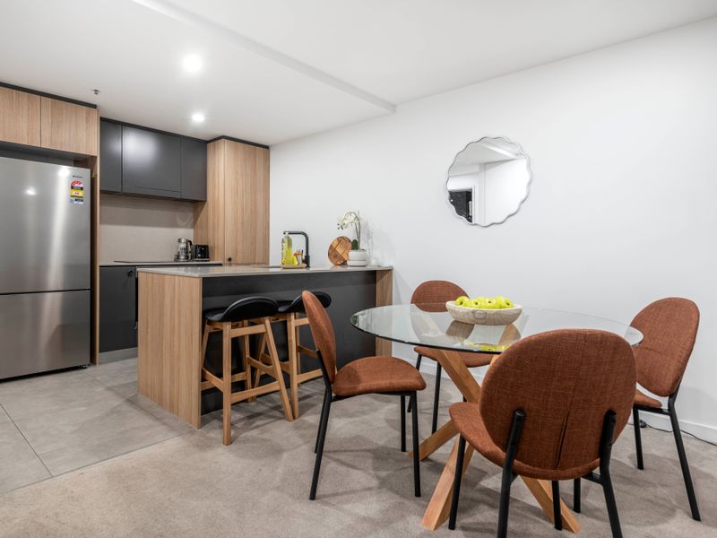 Dining area with seating for four beside the modern kitchen.