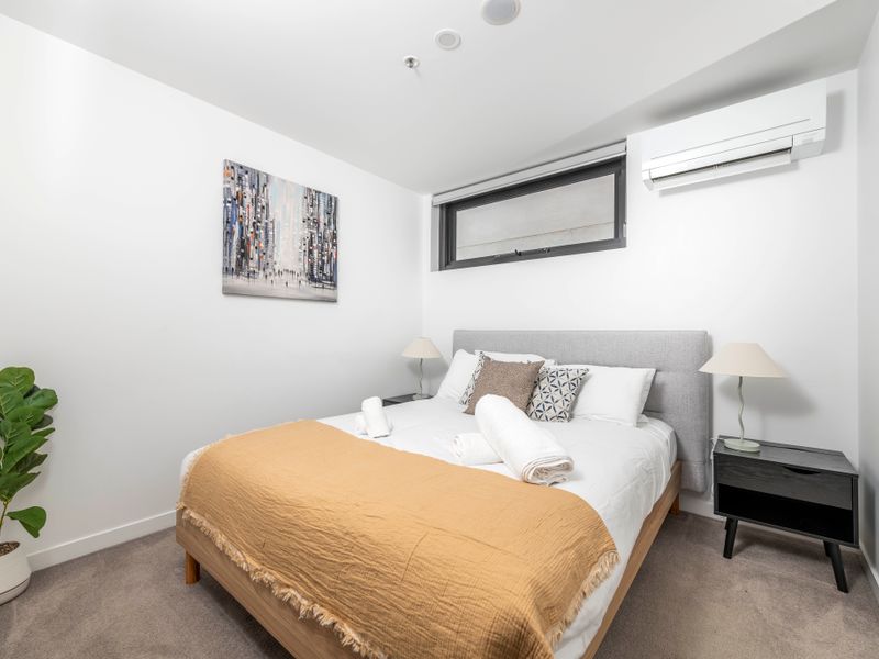 Master bedroom with queen bed and soft linens. Comfortable bed prepared with fresh towels.