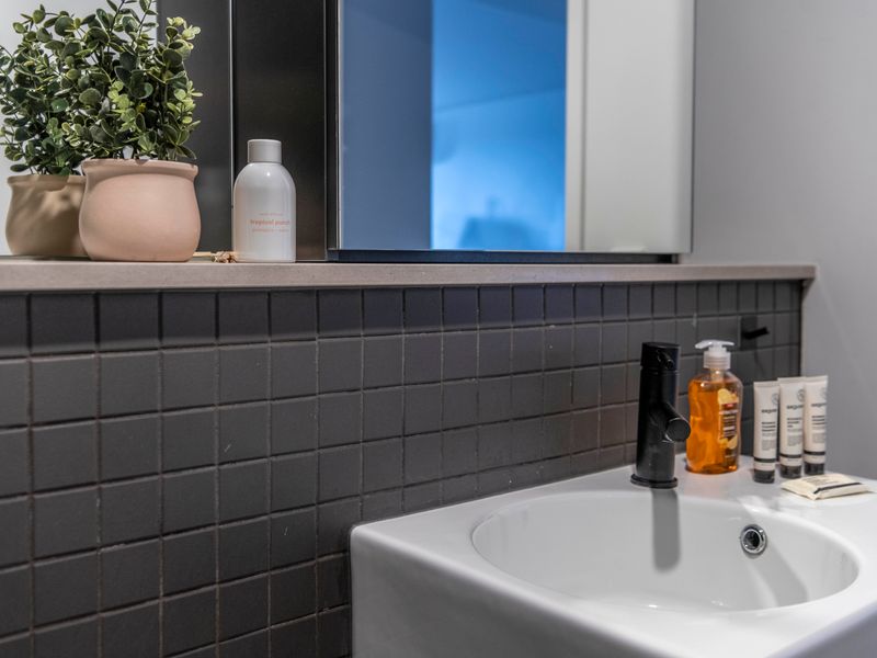 Elegant bathroom counter with thoughtful touches and essentials