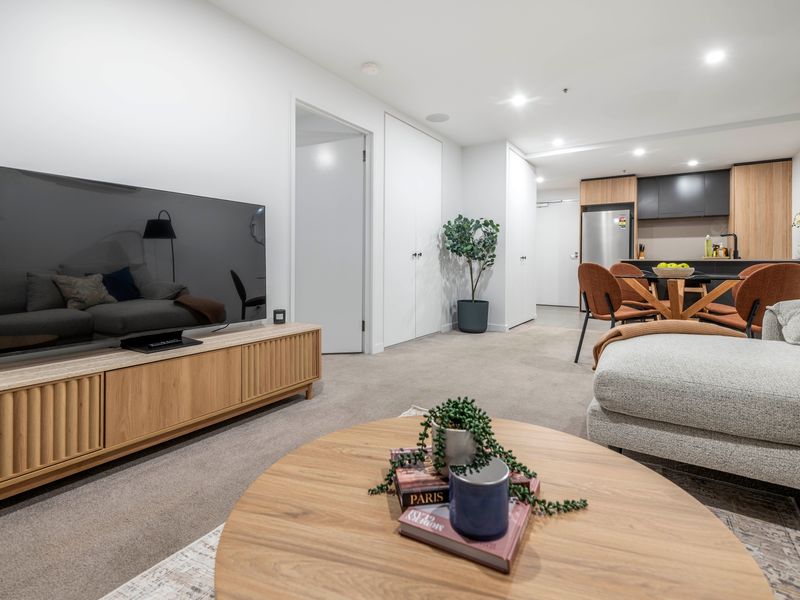 Spacious lounge with smart TV and stylish furnishings.