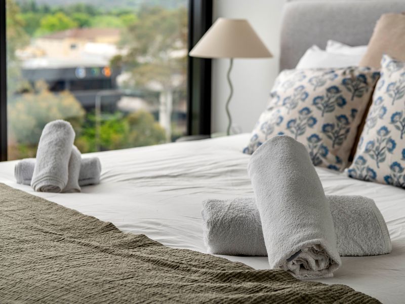 Cozy and stylish queen bed setup with fresh linens