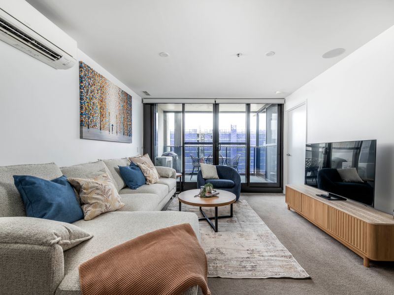 Living area opens to a private balcony with city views.