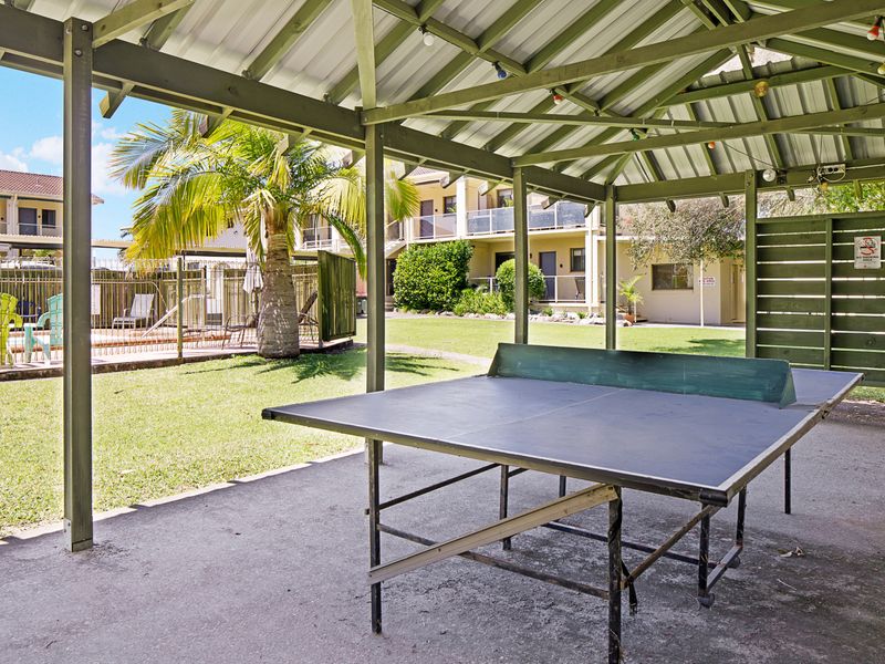 Outdoor entertainment area with ping pong table.
