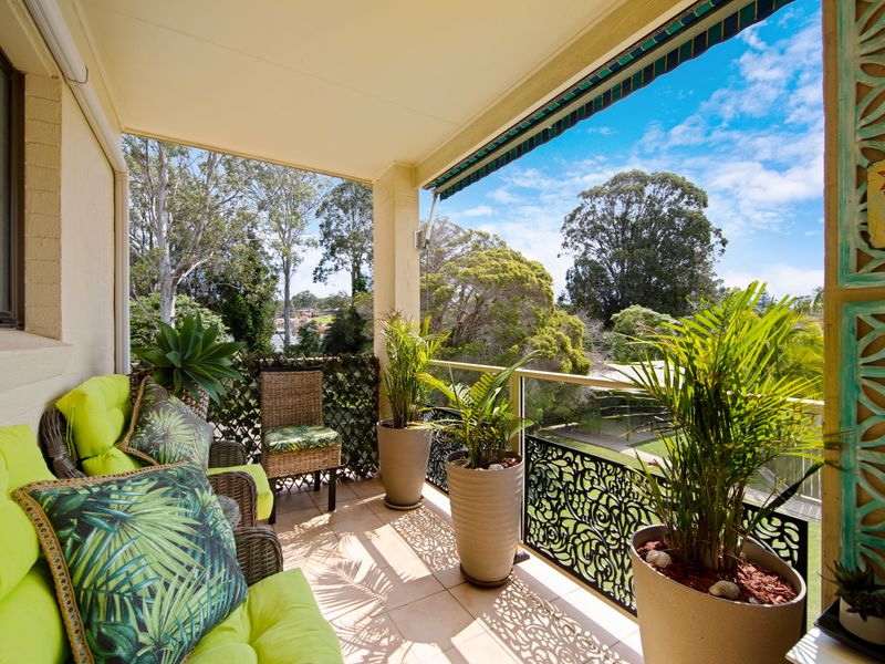 Outdoor patio with lush garden views and seating area.