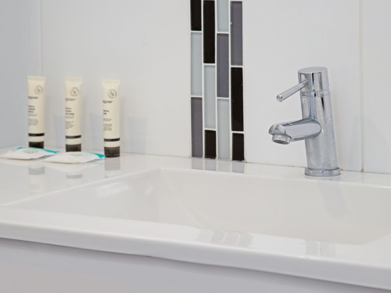 Modern vanity area with essential toiletries provided.