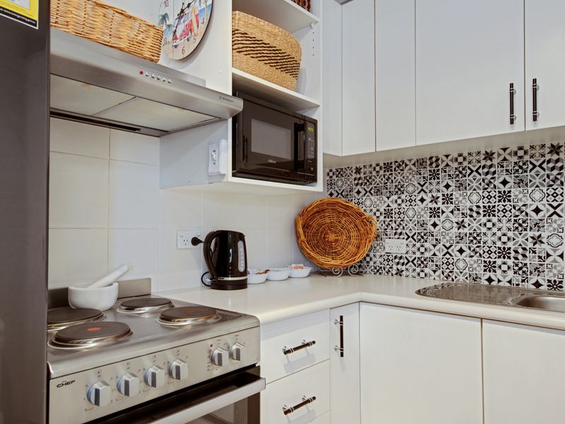 Fully equipped kitchen with stainless steel appliances.