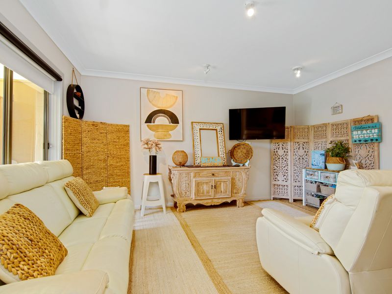 Light-filled living room with comfortable seating and beach-inspired décor.