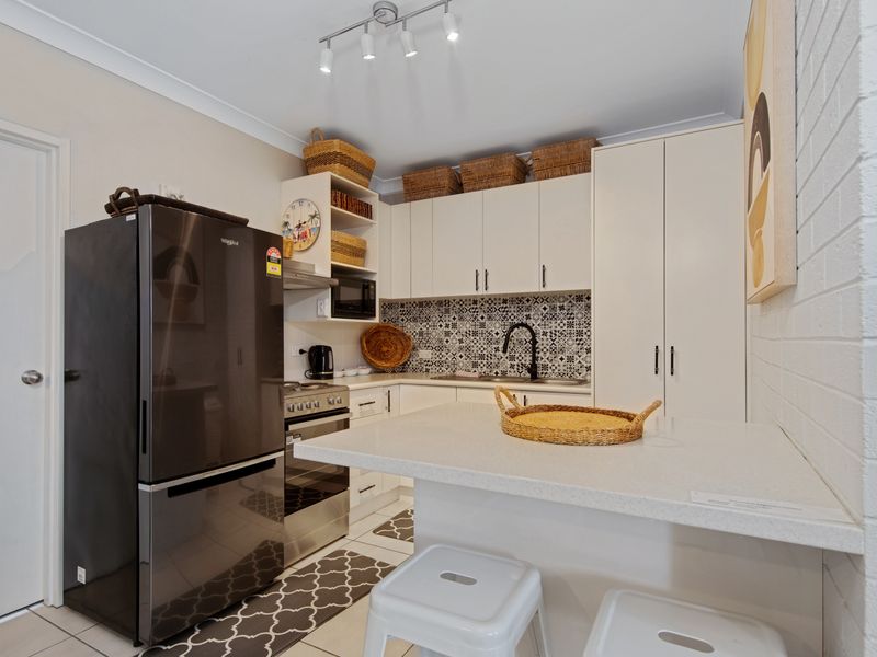 Kitchen featuring full-size refrigerator and ample storage.