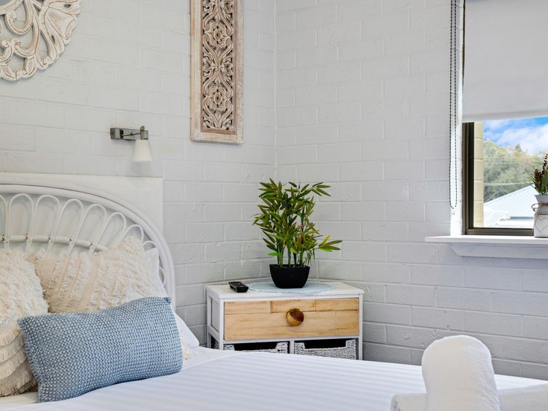 Light-filled bedroom with garden outlook.