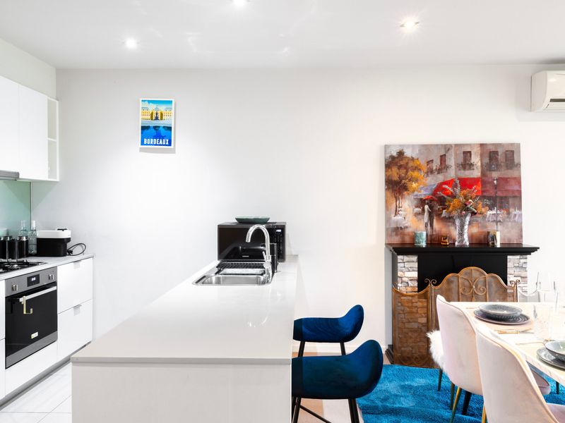 Sleek kitchen and breakfast bar for casual morning coffee or light meals.