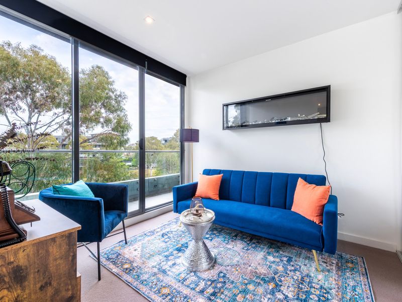 Cozy lounge area with river views and bright pops of colour.